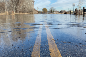Wet road with potential for hidden potholes